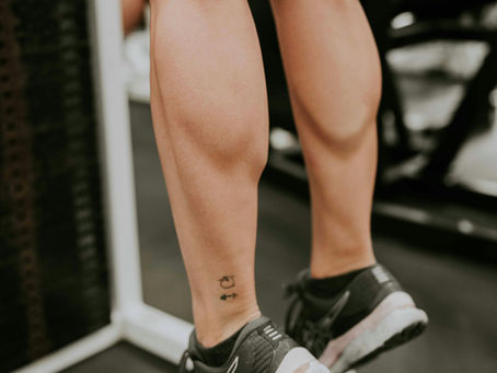An athlete doing calf raises using a calf raise machine
