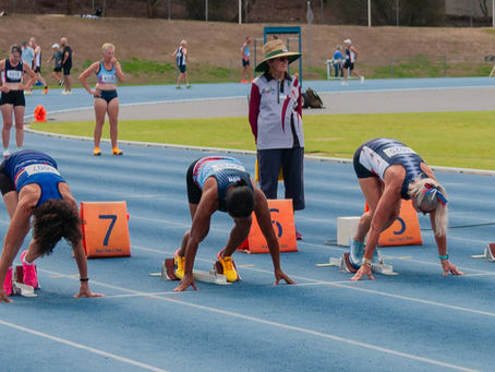 Female athletes on the blocks ready to start the race