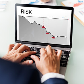 The image shows a person's hands typing on a laptop, with a graph displayed on the screen labeled "RISK." The graph depicts a downward trend, suggesting a decrease or loss, possibly in a financial or business context. A glass of water and some papers are visible on the desk beside the laptop. The scene likely represents work related to risk management, financial analysis, or business strategy. The graph on the laptop screen is a key element, emphasizing the concept of risk and its potential impact. The presence of the glass of water and papers suggests a typical office or work environment. The image comes from a page titled "Risk Management In Financial Assets: How To Do It Easily...". Alt text is useful for people with visual impairments, as it provides a text description of the image that can be read aloud by screen readers. It also helps search engines understand the content of the image, improving SEO. When writing alt text, it's important to be descriptive, concise, and accurate. 