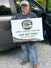 Real customer holding a professionally printed custom yard sign from Wrapco Graphics