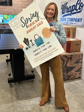Real customer holding a professionally printed custom yard sign from Wrapco Graphics