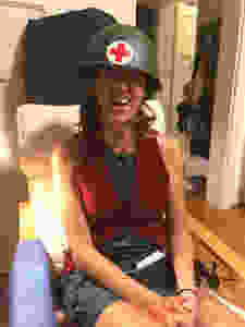 Woman wearing red cross medic helmet.