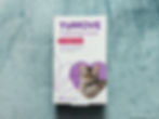 Box of YuMOVE Calming Care capsules for adult cats on a textured blue surface.