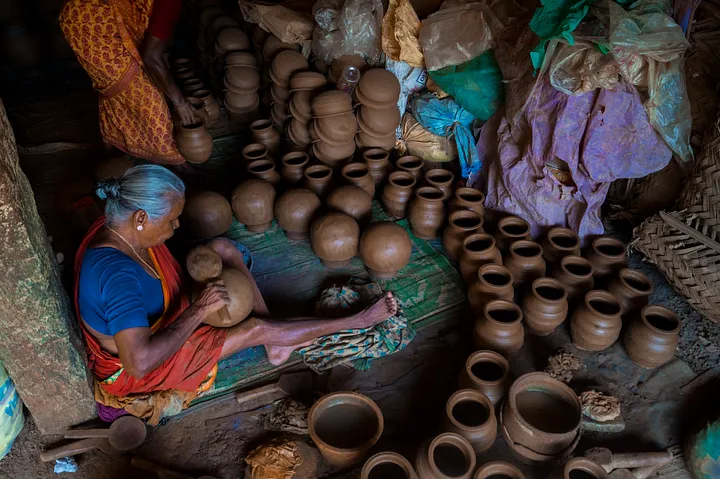 a woman shaping pots
