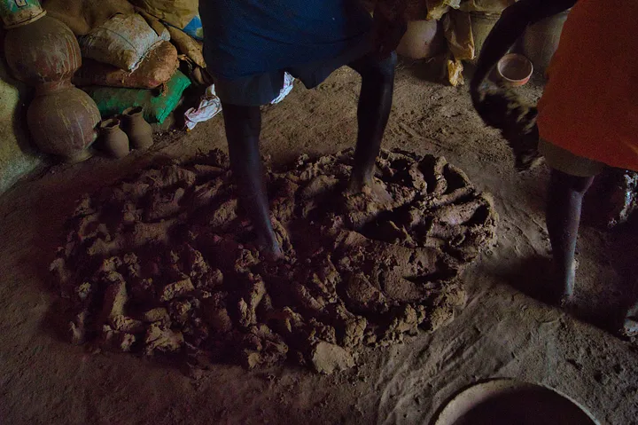 man stomping and mixing mud