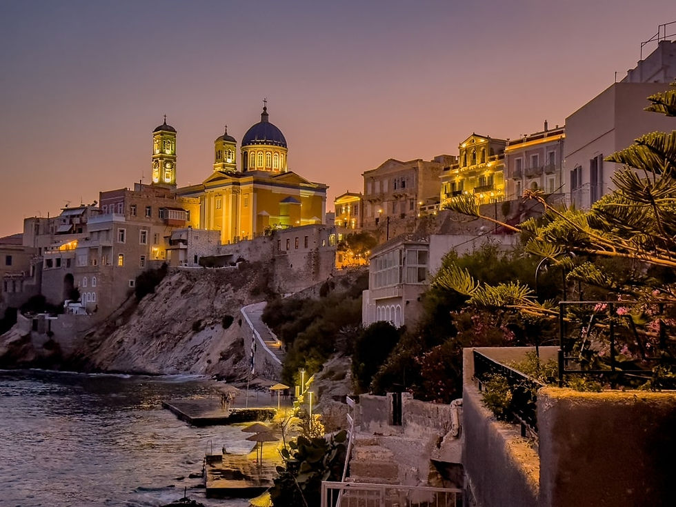 Aerial view of a rocky coastline with clear turquoise ocean, surrounded by rugged cliffs and sparse greenery, evoking a serene and natural vibe.