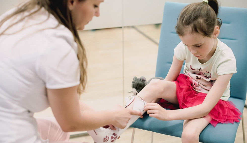 Clinician fitting new AFO & SMO orthoses to child