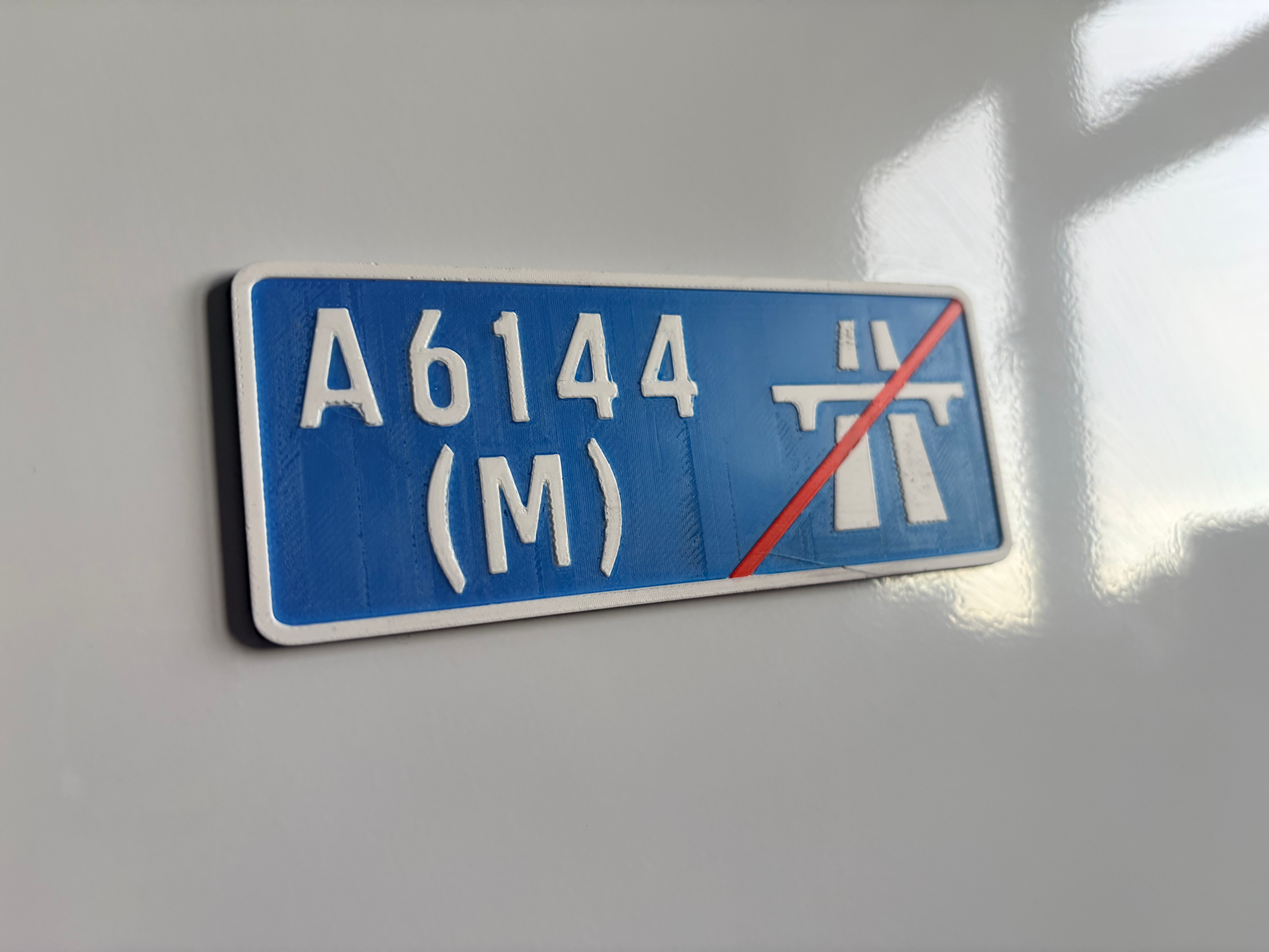 A6144(M) fridge magnet with red strikethrough