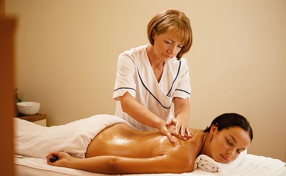 young-woman-having-back-massage-by-female-therapist-spa-focus-is-massage-therapist.jpg