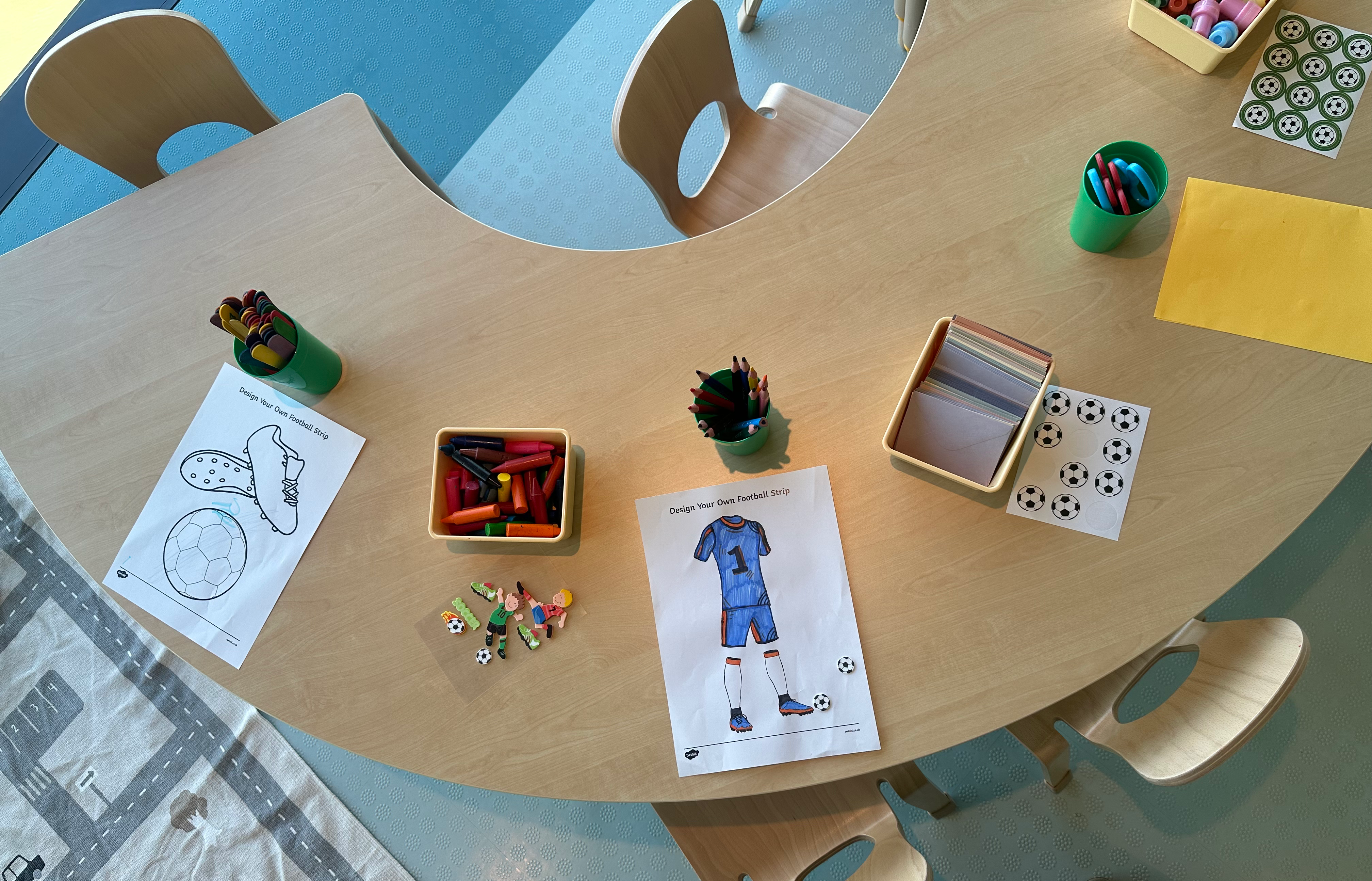 A vibrant children crèche setup with soft mats and colorful learning toys in a clean environment.