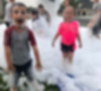 A boy and a girl at a foam party