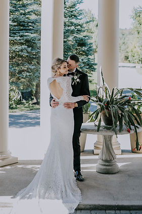 “Brighthouse Farm wedding couple embracing outdoors in rustic natural setting”