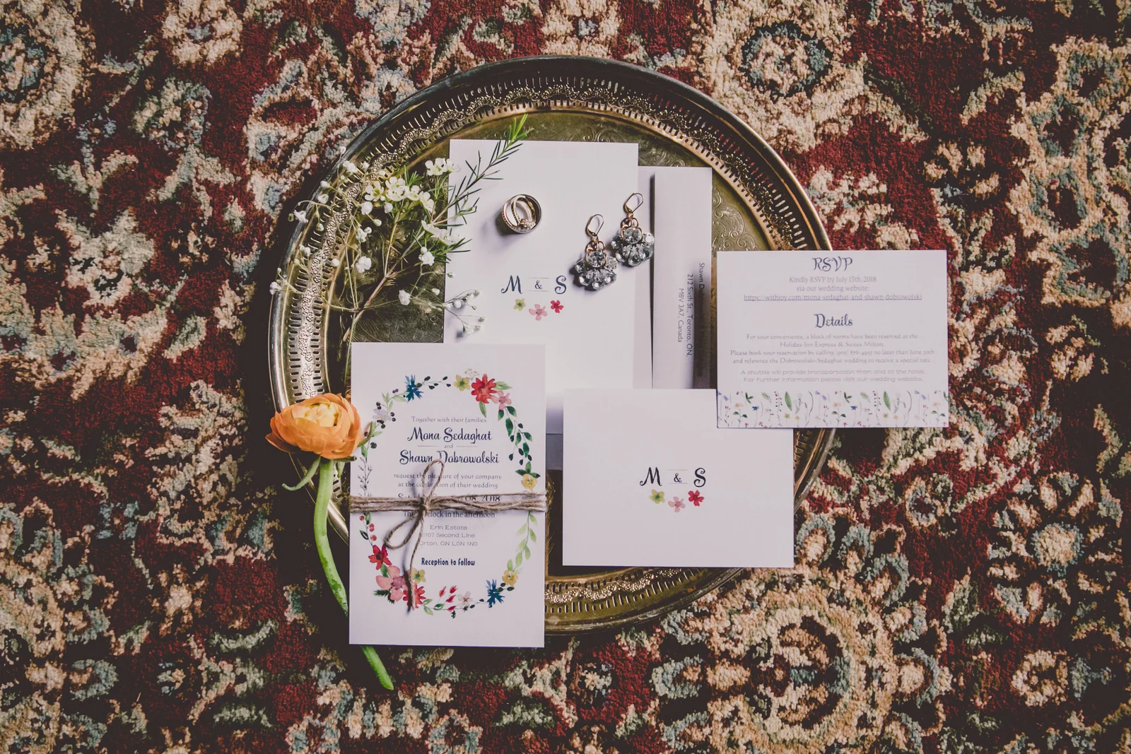 mage of elegant wedding stationery including invitations, place cards, and thank you notes with floral motifs and custom monograms for the bride and groom