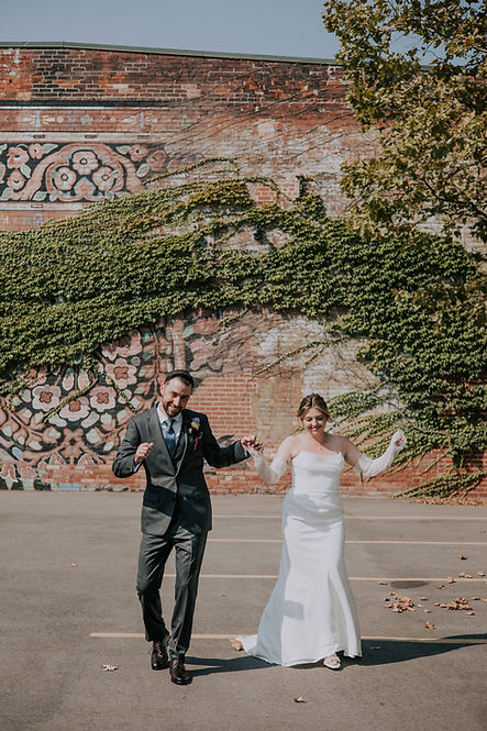 Candid wedding photography in downtown Liberty Village, Toronto. A bride and groom sharing a laugh against a modern urban backdrop by Olive Studio.