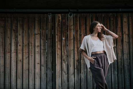Woman posing against rustic wooden wall for authentic branding portrait