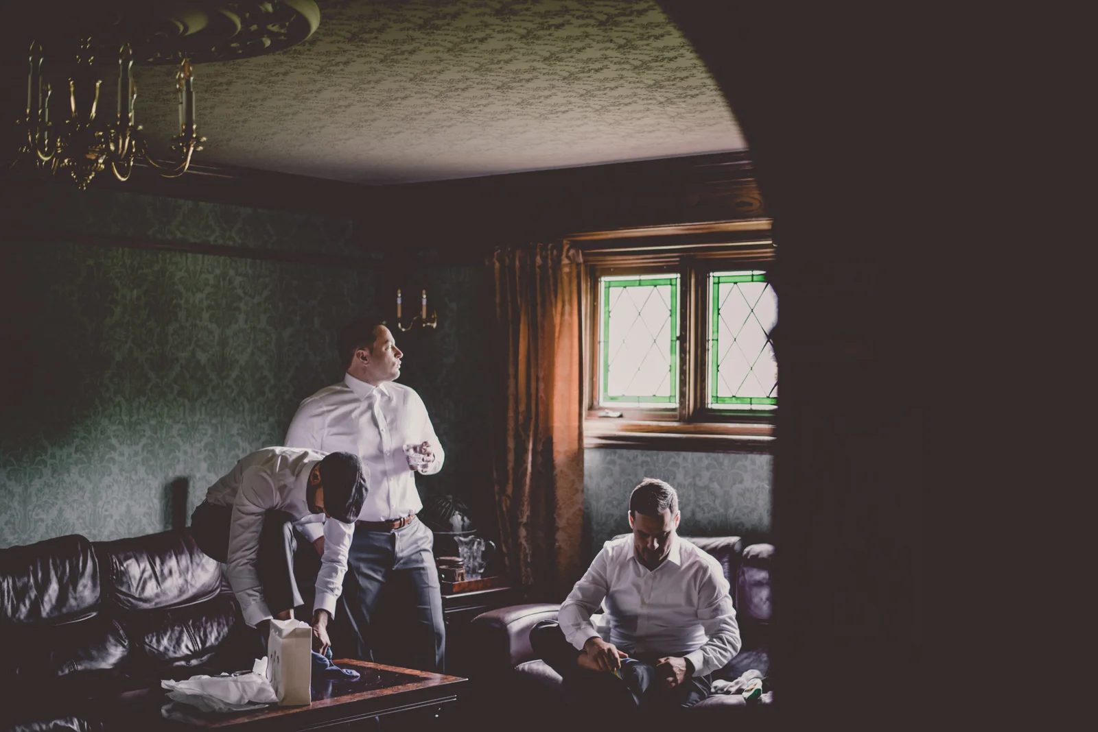 3 men put on their suits at the Erin Estate