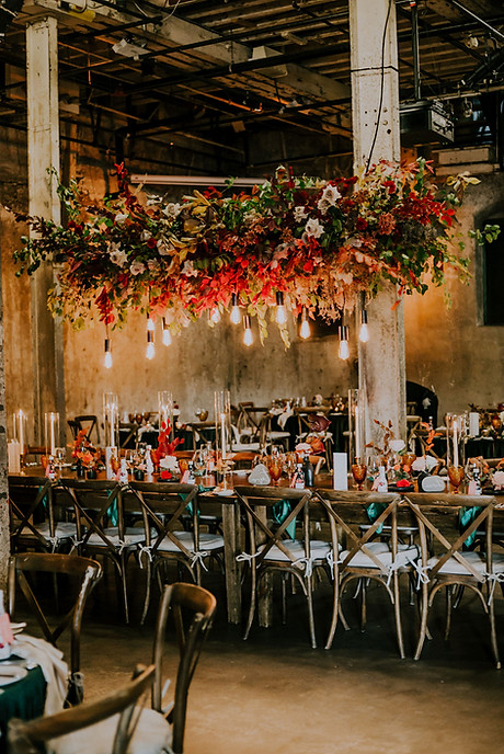 An autumn inspired floral hanging center piece above the head table dazzles guests at the Fermenting Cellar, Toronto