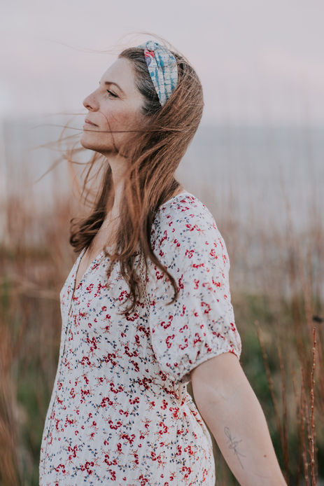 Woman looking away in soft natural light for serene personal branding headshot