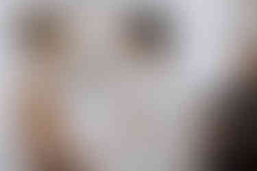 two women holding hands while smiling at one another. 