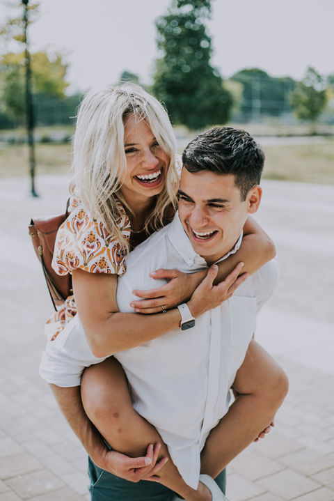 Groom playfully carrying bride during portraits