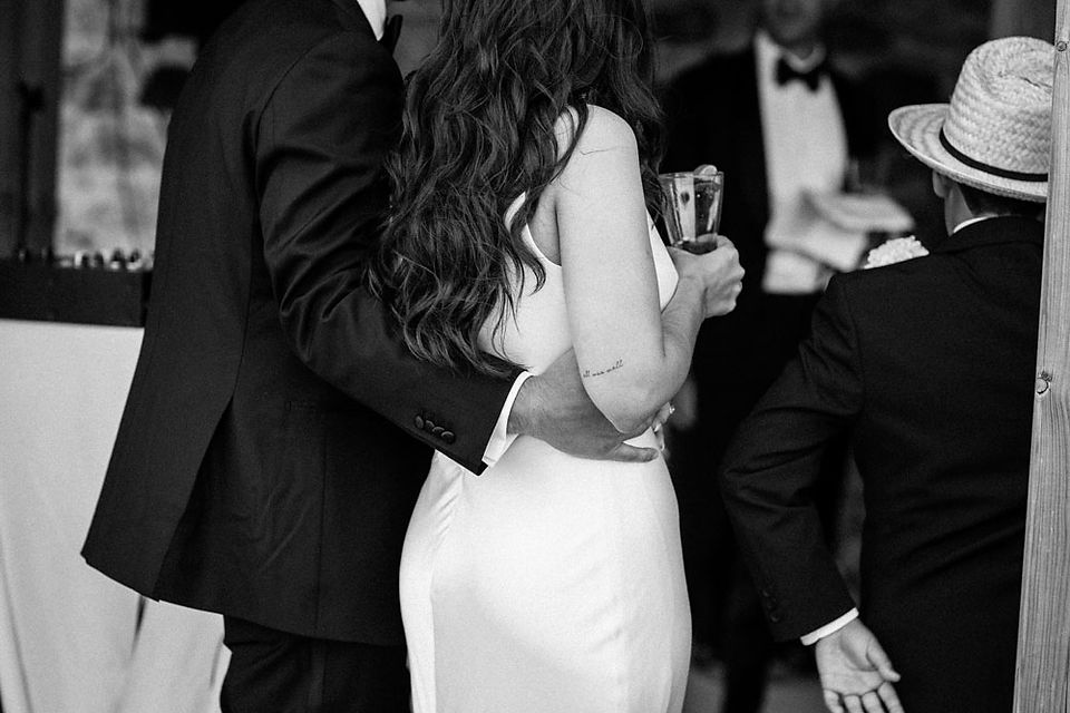 groom caresses bride's hip