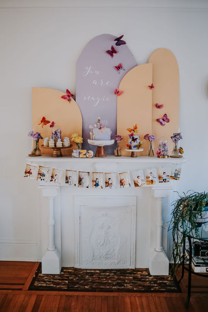 Pastel butterfly themed dessert table with arched backdrop and floral accents in Hamilton.