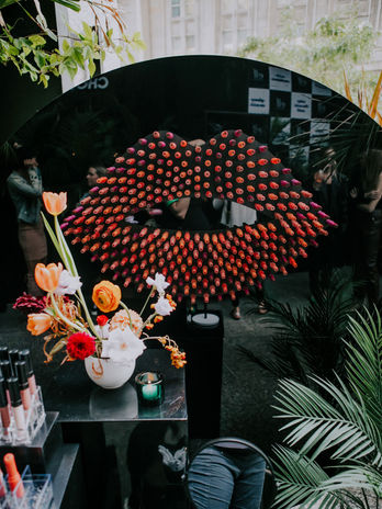 Large-scale red lipstic mosaic art installation for events.