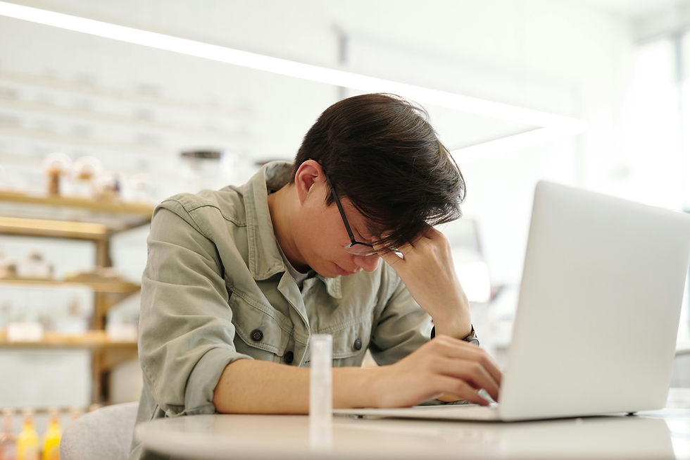 Man sitting at a table looking emotionally exhausted