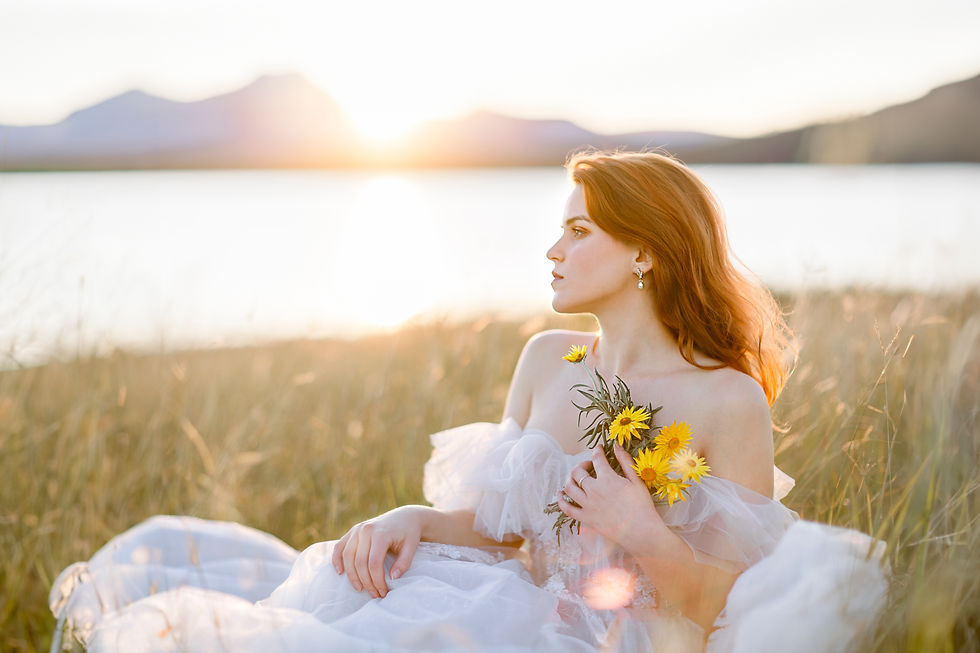 Captivating Brisbane sunset photography featuring a female model holding flowers by a serene lakeside.