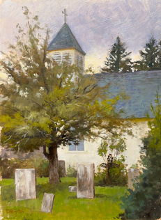 Old white church with a steeple and a graveyard on a cloudy day