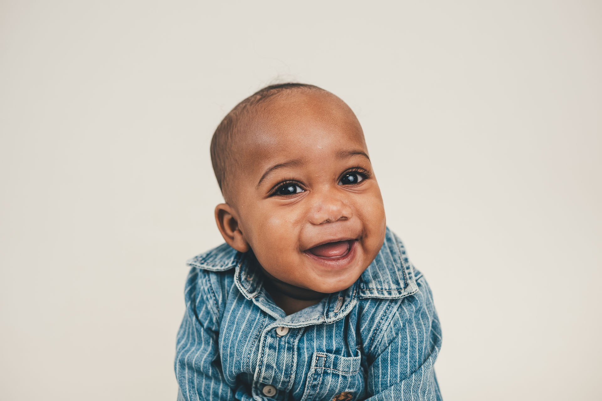 miling baby wearing a denim outfit for school picture day