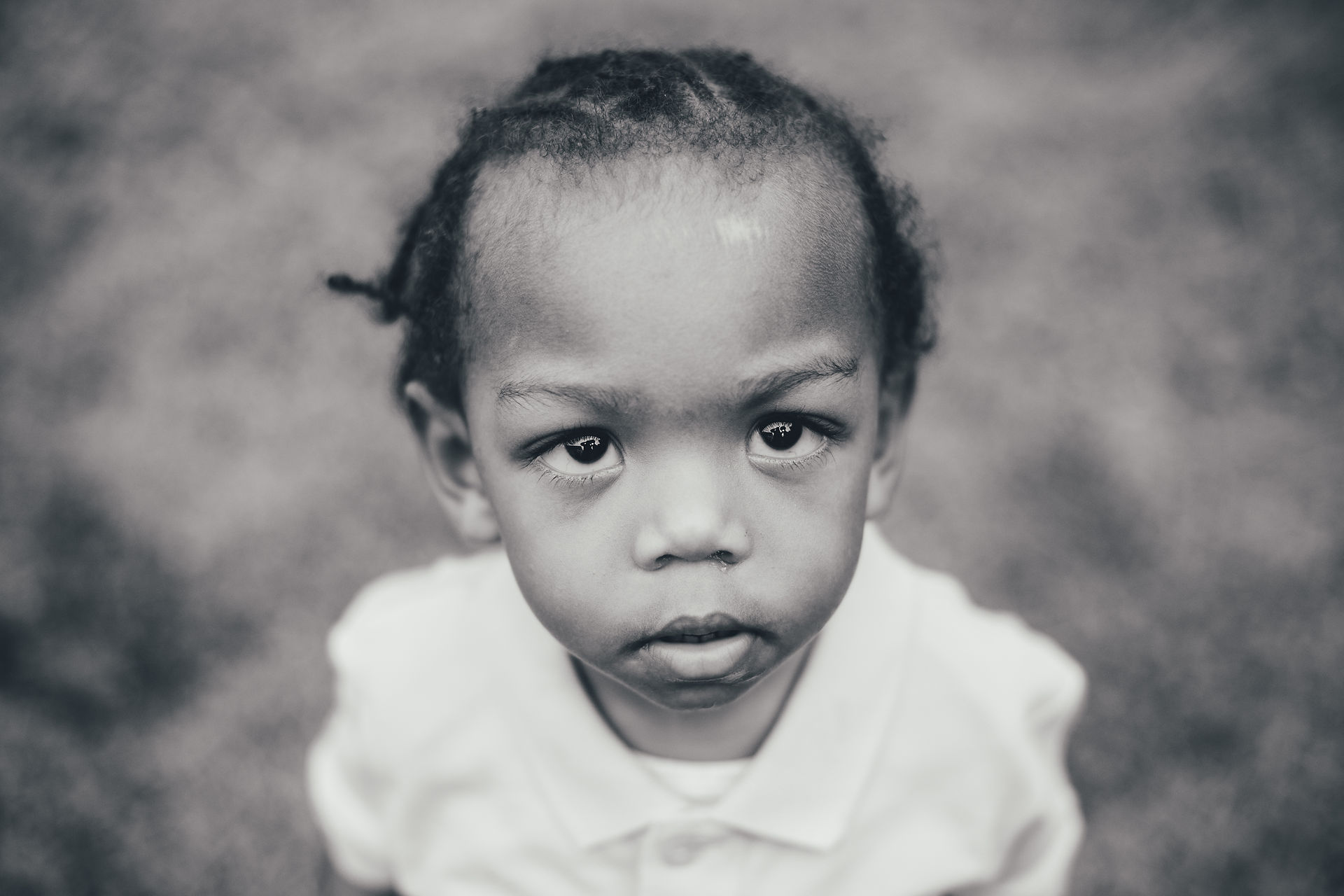 Black and white school portrait of a young boy with a serious expression