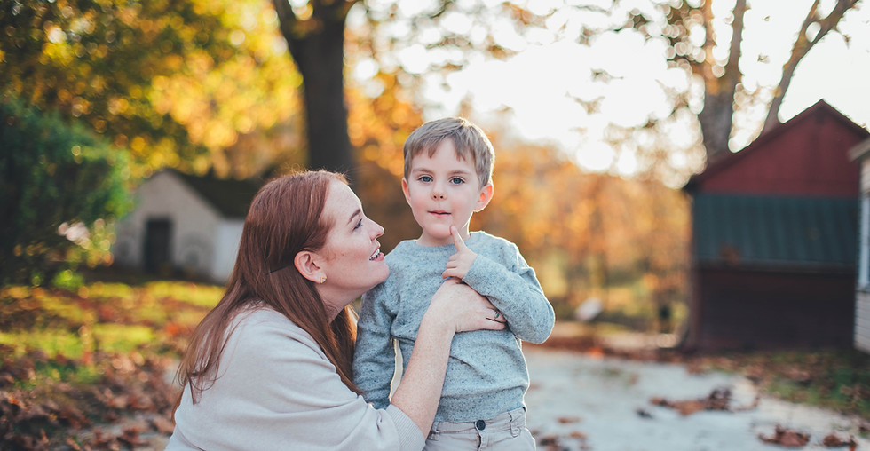 Mother kneeling next to her son