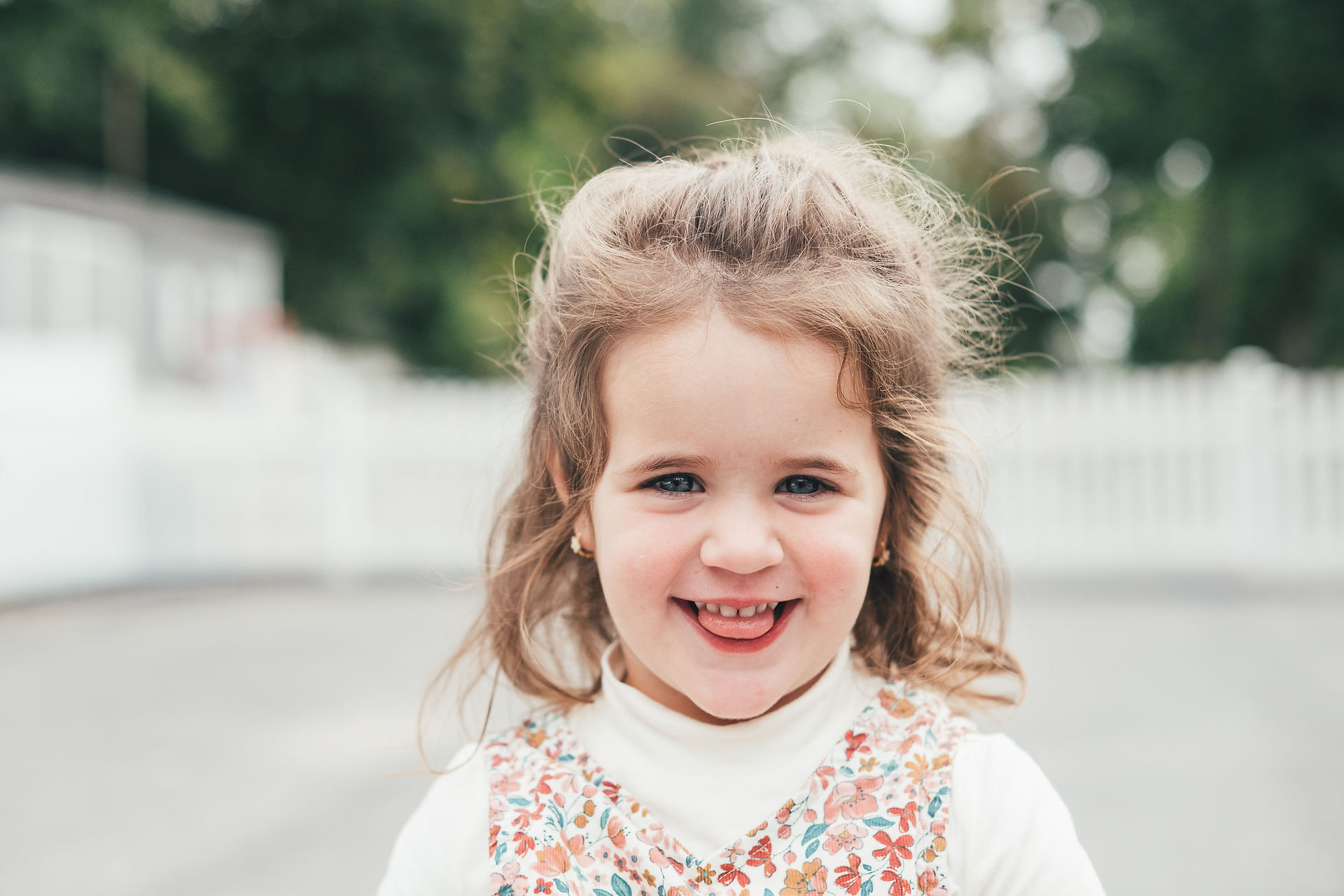 Girl wearing a floral dress and white turtleneck for outdoor school pictures