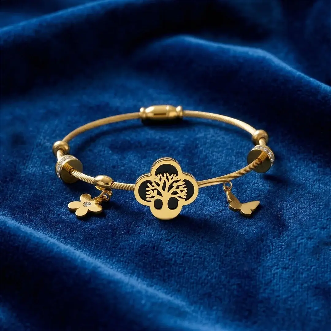 Gold-toned cable Kada bracelet for women with a central black enamel Tree of Life charm