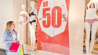 happy-young-woman-looking-window-display-clothing-store.jpg