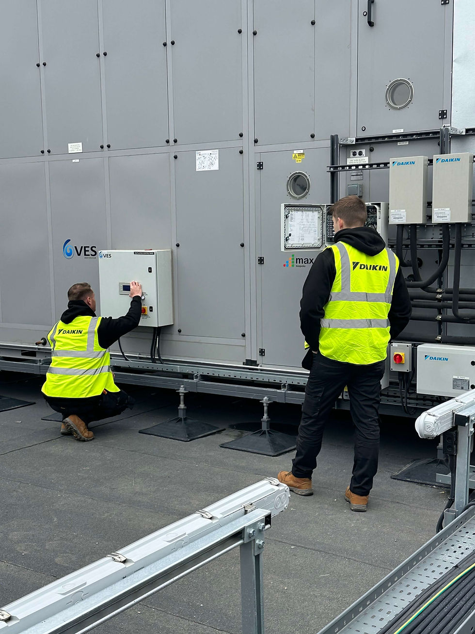 Engineers installing a large commercial air conditioning system.