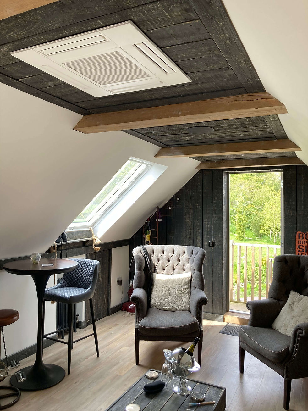 Ceiling cassette air conditioning unit installed in a loft living space.
