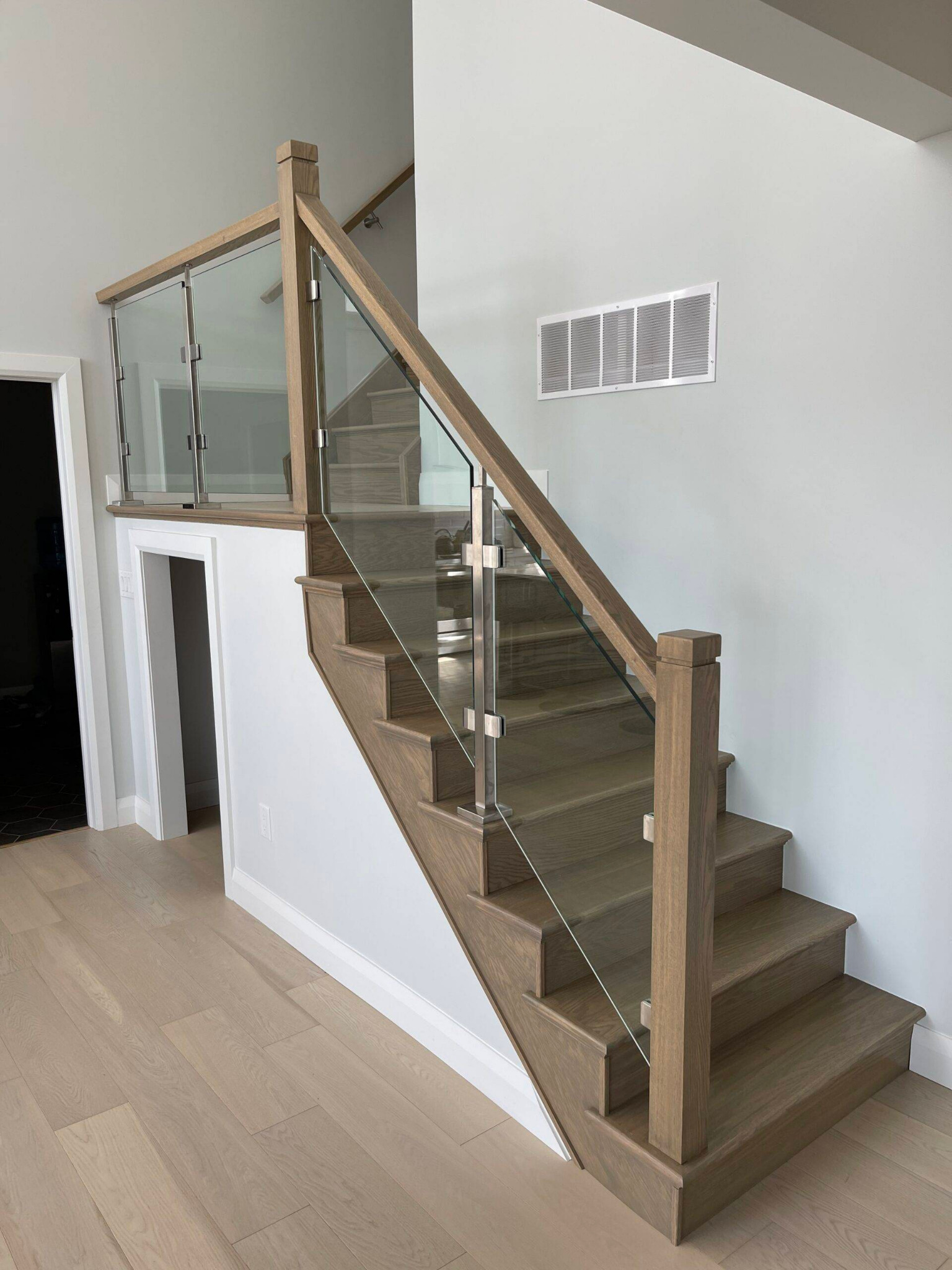 Interior staircase with custom railing and glass panels