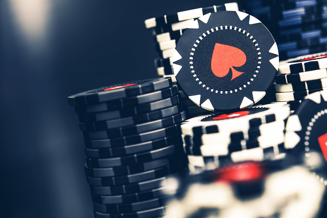 Tall Pile Of Black And White Casino Poker Chips With Red Spade Symbol_edited.jpg