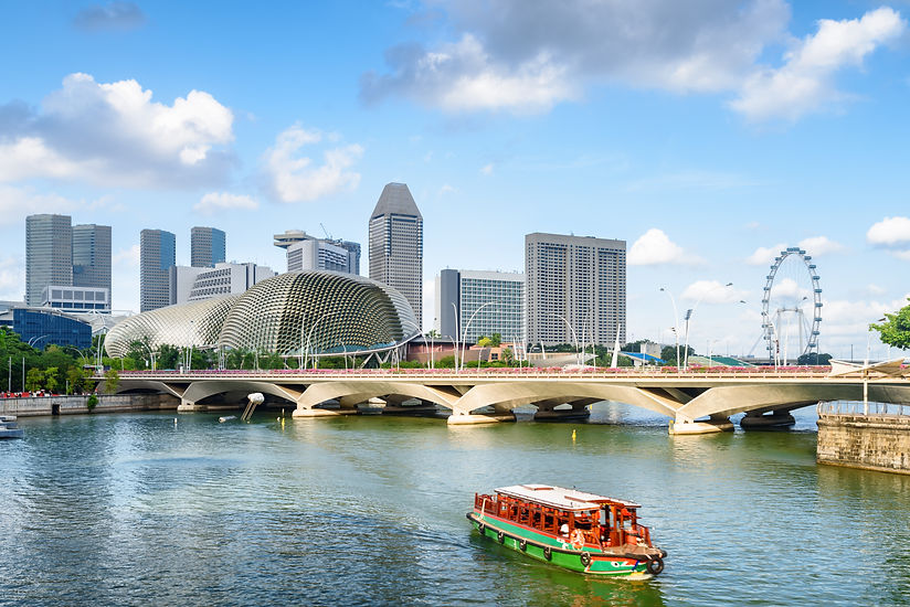 Beautiful view of traditional tourist boat sailing along Marina Bay with azure water in Si