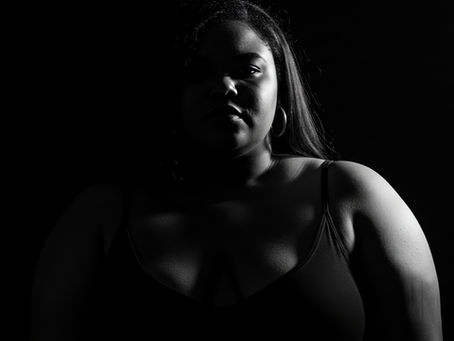 black and white photo of woman in darkness