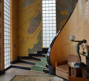 Hallway with stairs spiralling up in the background