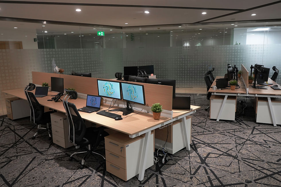 Bluewave Solutions office workspace with modern desks, dual monitors, and a clean, minimalistic design.