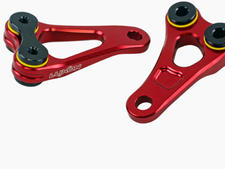 Close-up of red Luxon engine brackets for Ducati Desmo450 on light grey background, highlighting new arrivals at MX Factory Parts.