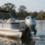 Silver outboard motor on a boat and pontoon refitting.