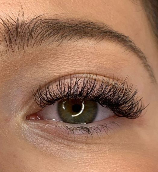 High angle view of a makeup artist applying false lashes