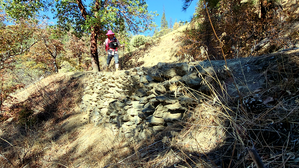 stone retaining wall with trail running on its top