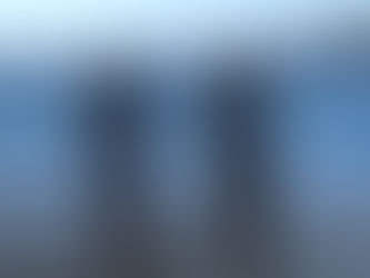 Two blonde girls running at a beach, happy and at ease.