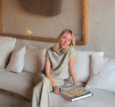 Rahel Kubach, founder of CIELO Collective, sitting in a beautifully styled Mediterranean space — embodying the spirit of mindful living, creativity, and wellbeing travel. A serene portrait capturing the essence of slow living, feminine leadership, and soulful retreat experiences in Mallorca.